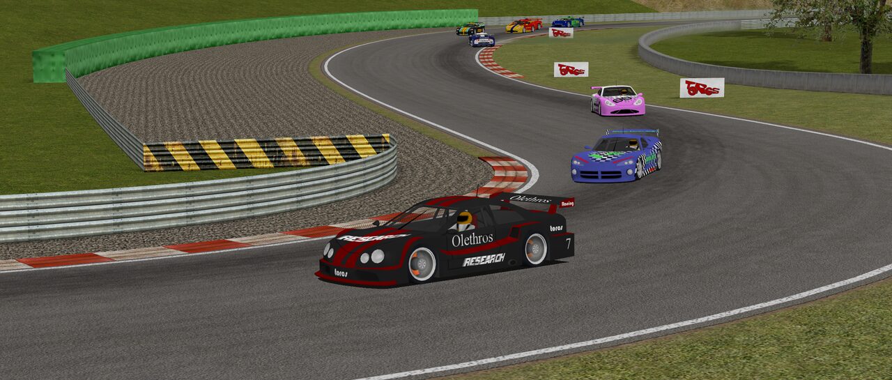 A black-and-red TORCS race car leads a field through a sweeping bend